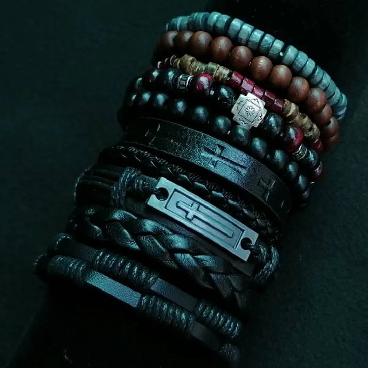 Stack of various bracelets on a dark background