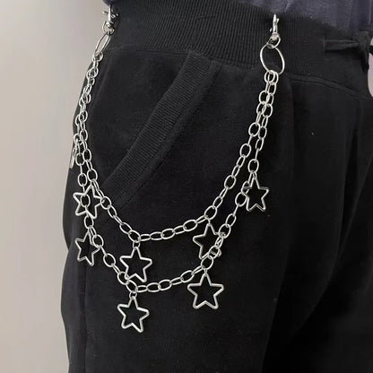 Silver chain belt with star charms worn by a person on a plain background