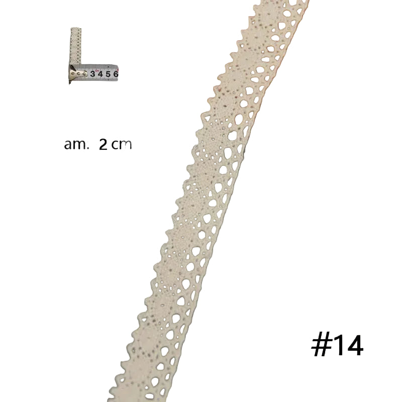 Decorative lace trim on a white surface with a wooden board and measurement scale.h