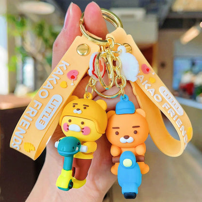 Keychain with cartoon characters and 'Kakao Friends' branding held by a hand.