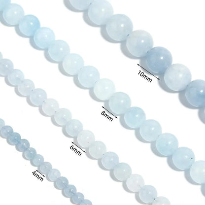 Close-up of light blue beads with size measurements on a white background