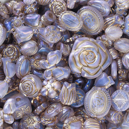 Close-up of decorative buttons with floral and geometric designs in gold and silver.