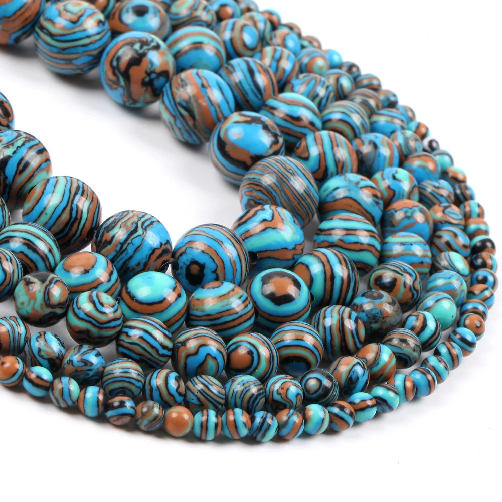 Multiple strands of round beads with a marbled pattern of turquoise blue, brown, black, and white, arranged in a spiral on a white background.