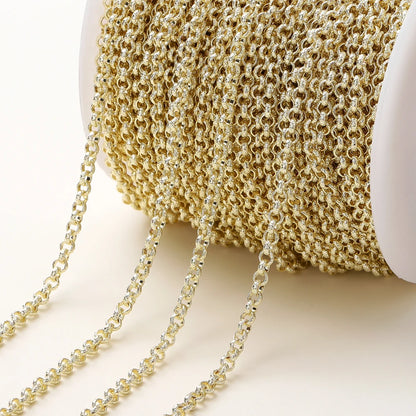 A close-up of a gold-tone chain draped over a white spool, showing the fine interlocking links of the chain against a clean white background.