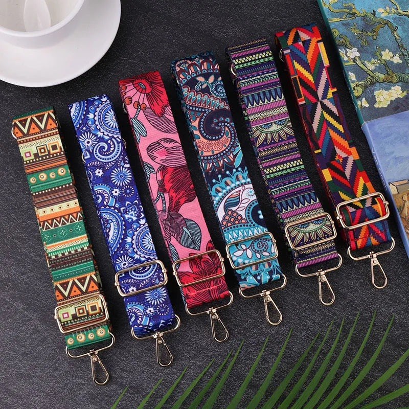 Colorful patterned straps with metal clasps on a dark surface