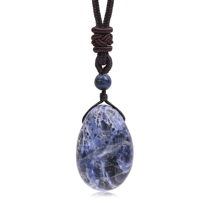 Blue stone pendant on a black cord against a white background