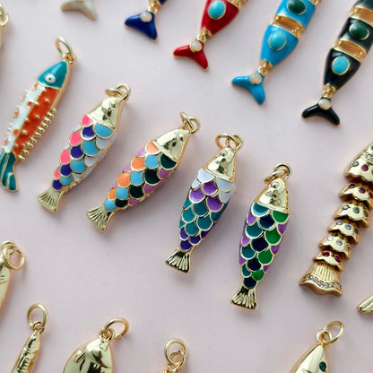 Colorful fish-shaped charms on a light pink background