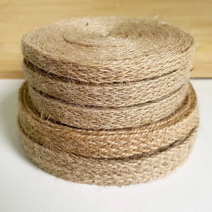 Stack of brown jute twine on a white surface with a wooden background