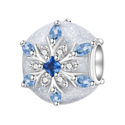 A round silver charm bead featuring a snowflake design with a central blue gemstone, surrounded by clear rhinestones and light blue marquise-cut gemstones on a glittery white background.