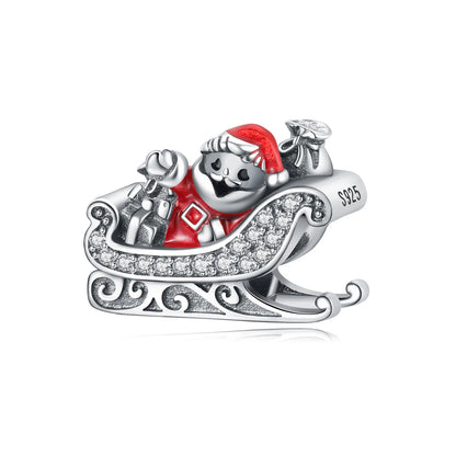 Silver charm with Santa Claus on a sleigh, red background