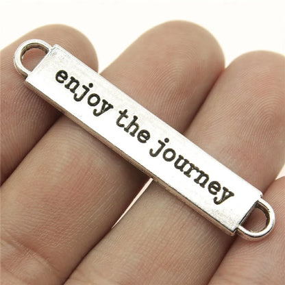 Travel charms for jewelry making featuring airplane, passport, suitcase and camera charms.