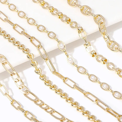 Gold chains displayed on a white background .