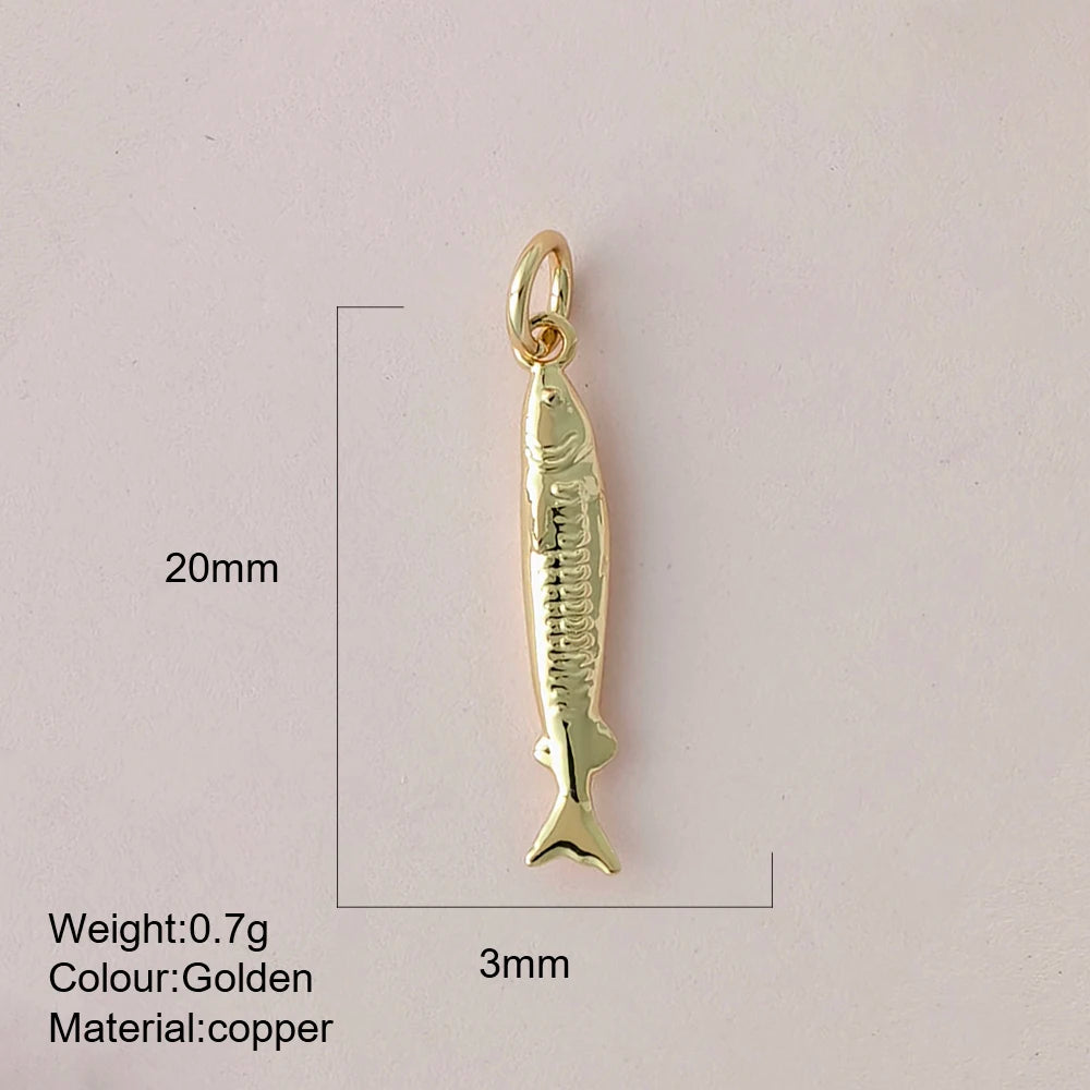 Gold fish-shaped pendant with measurements and material details on a light gray background