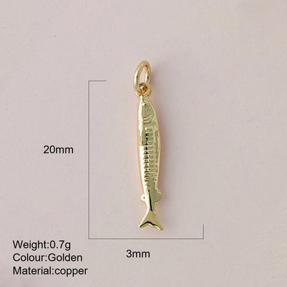 Gold fish-shaped pendant with measurements and material details on a light gray background