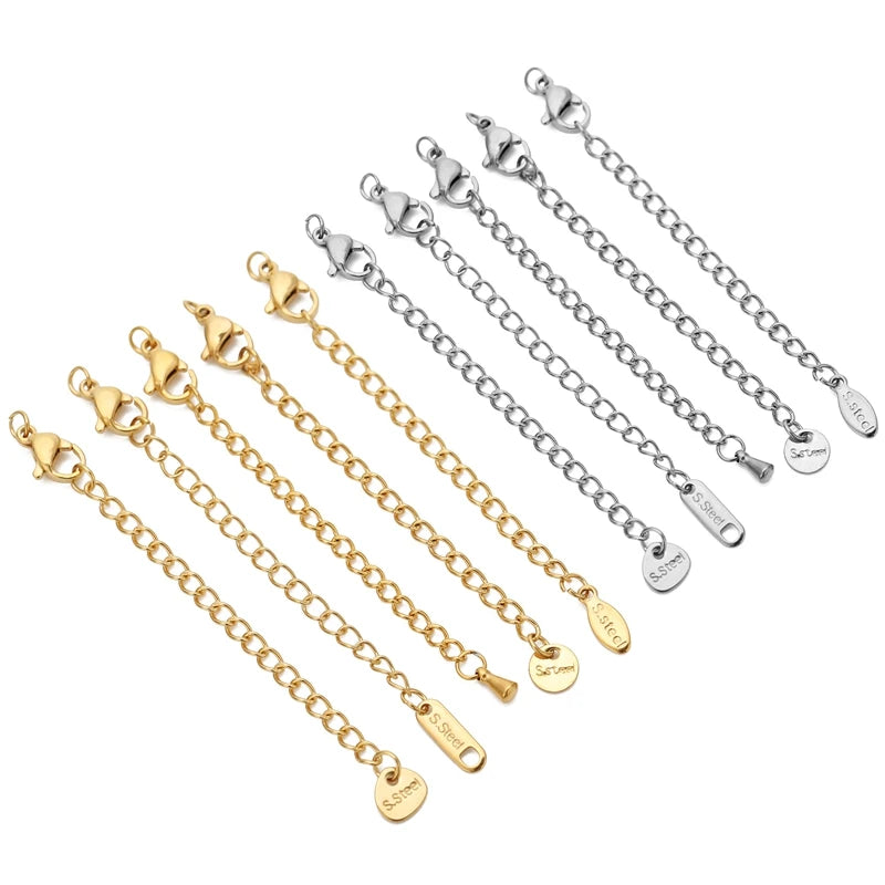 Set of gold and silver chain bracelets with attached charms on a white background