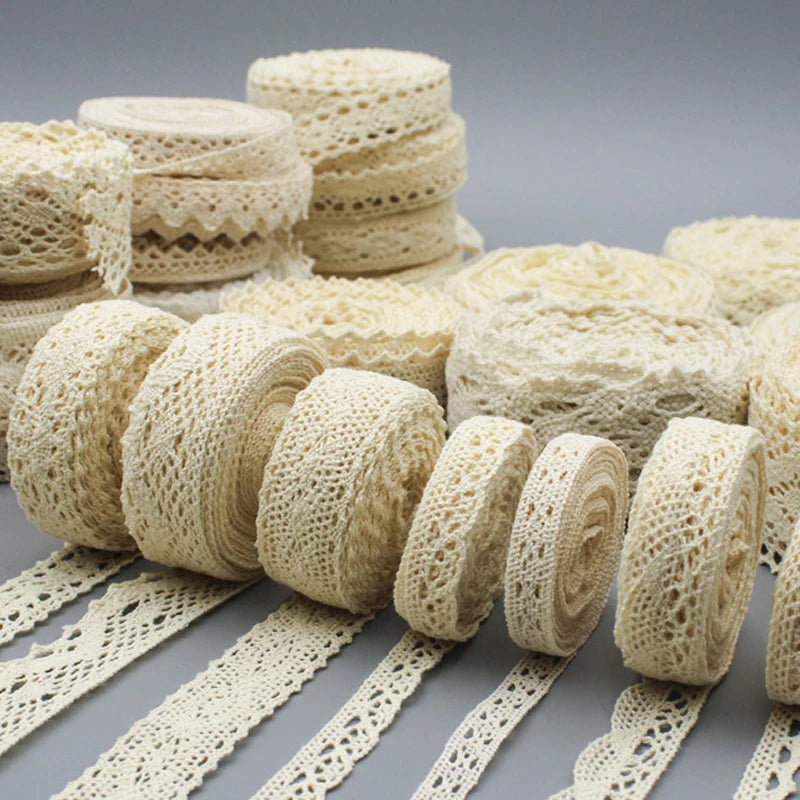 Collection of beige lace ribbons on a gray background