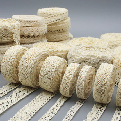 Collection of beige lace ribbons on a gray background