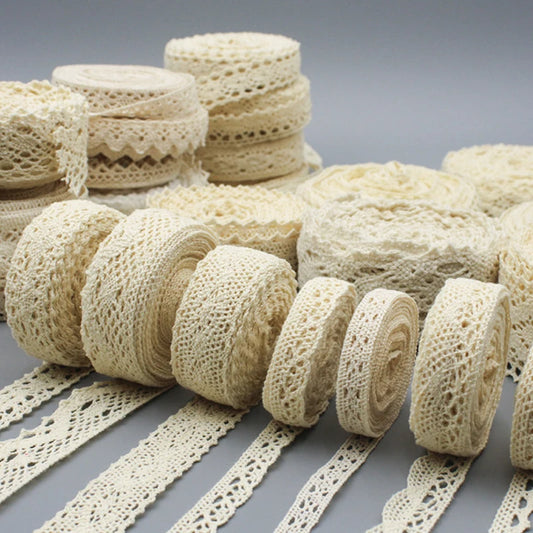 Collection of beige lace ribbons on a gray background
