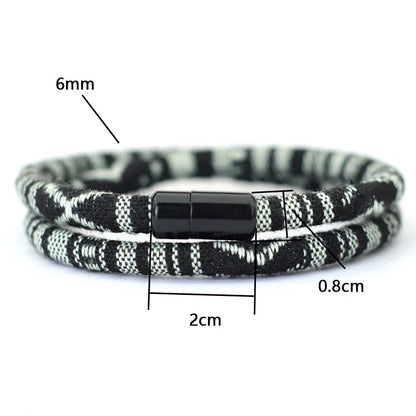 Black and white braided bracelet with measurements on a white background