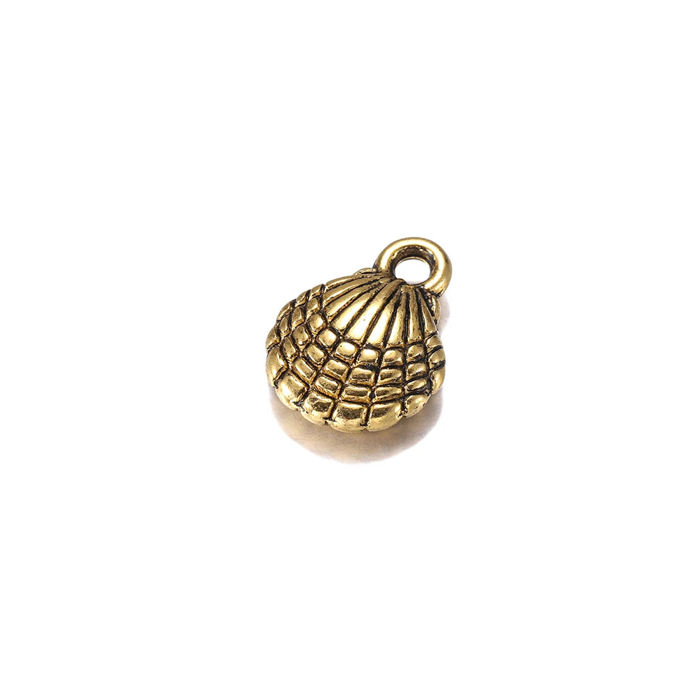 An antique bronze seashell jewelry charm with a textured shell pattern and a top loop, shown on a plain white background.