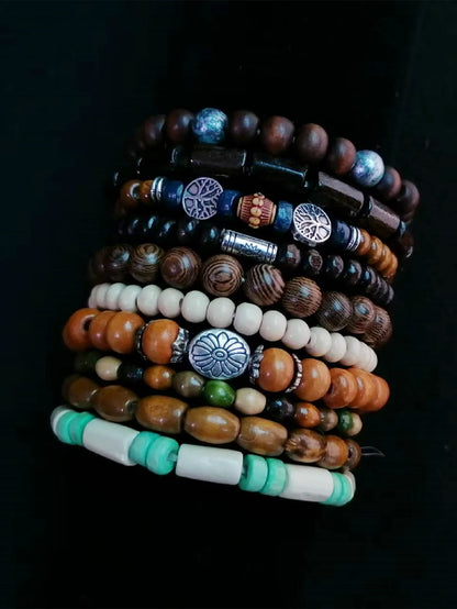 Stack of various beaded bracelets on a dark background