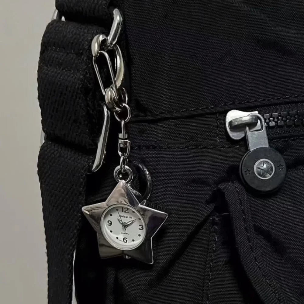 Star-shaped clock charm attached to a black bag
