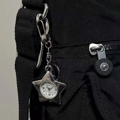 Star-shaped clock charm attached to a black bag