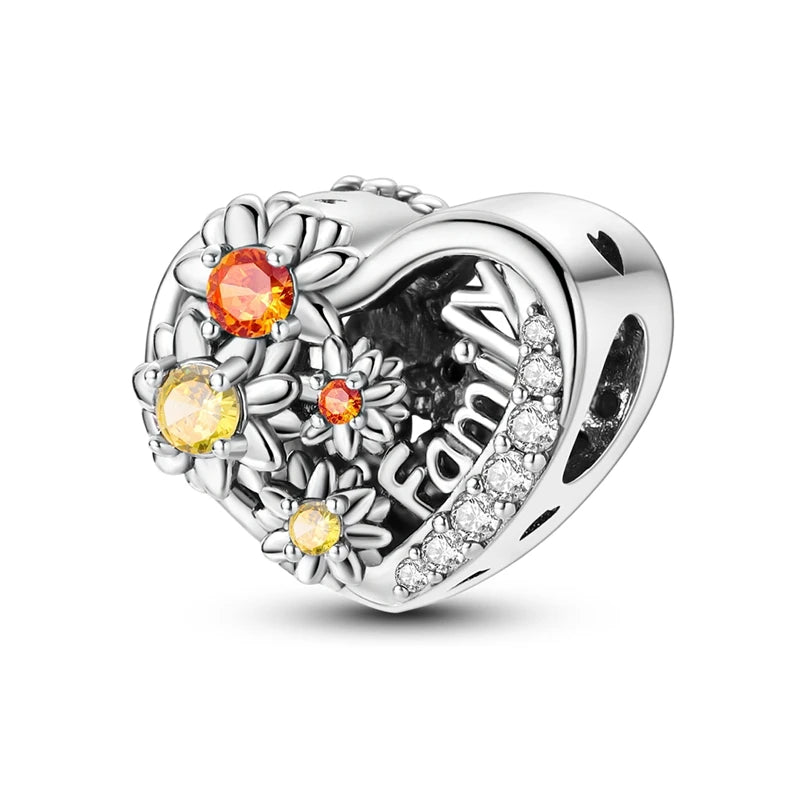 Heart-shaped silver charm with colorful stones and 'family' engraving on a white background