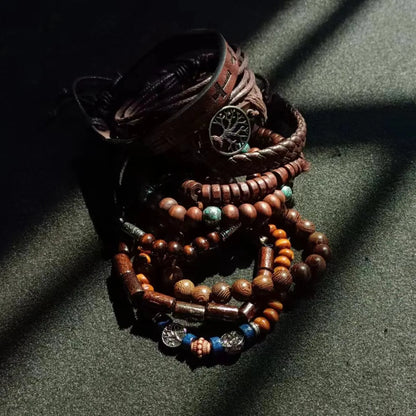 Stack of wooden beaded bracelets with a dark background