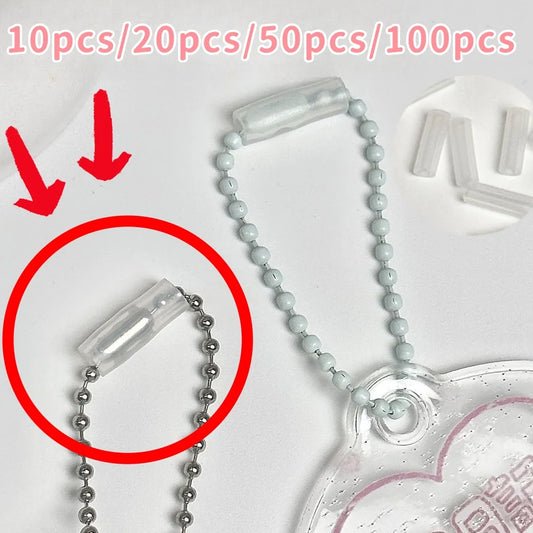 Clear plastic bead ball chain accessory with a silver ball chain and a translucent heart-shaped charm, shown on a white background with red arrows and text indicating quantity options.