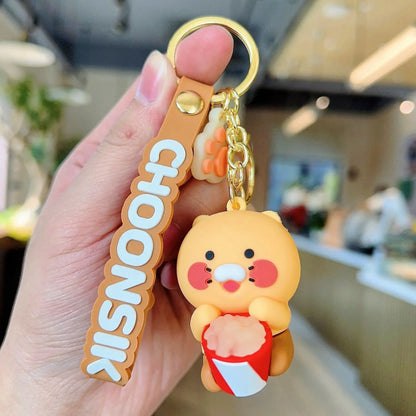 Keychain with cartoon character and 'CHOONSIK' text held in a hand.