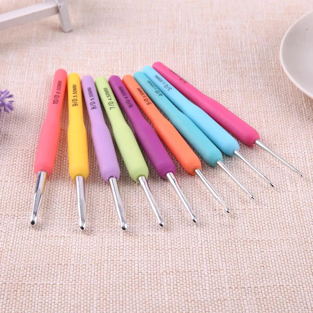 Set of colorful crochet hooks on a textured surface