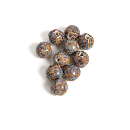 A cluster of nine round, glossy ceramic beads with a mottled blue-gray and brown pattern, arranged on a plain white background.