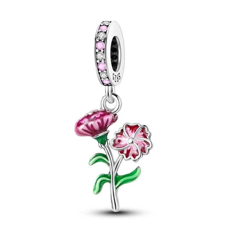 Silver charm with pink and red flowers on a white background
