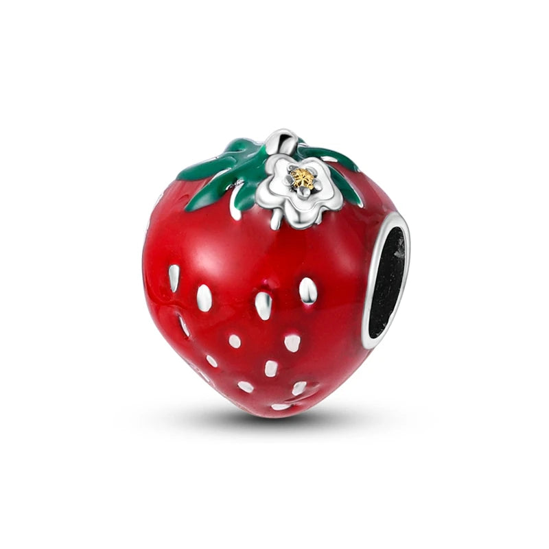 Strawberry-shaped charm with a flower on a white background