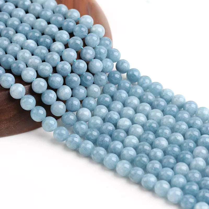 String of light blue beads on a wooden bead holder