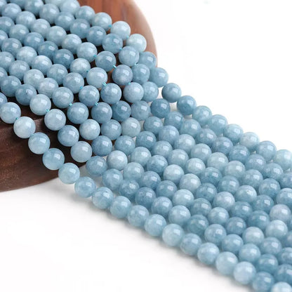 String of light blue beads on a wooden bead holder