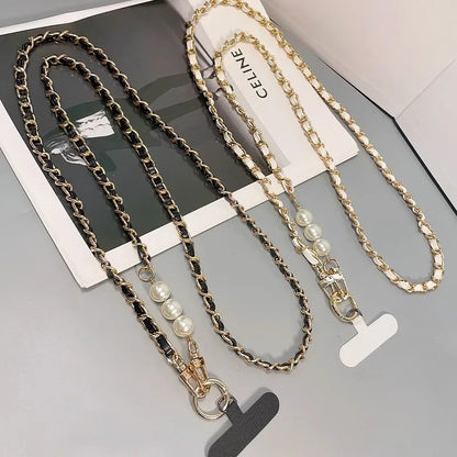 Two chain necklaces with pearl accents on a gray surface, one branded 'Celine'.