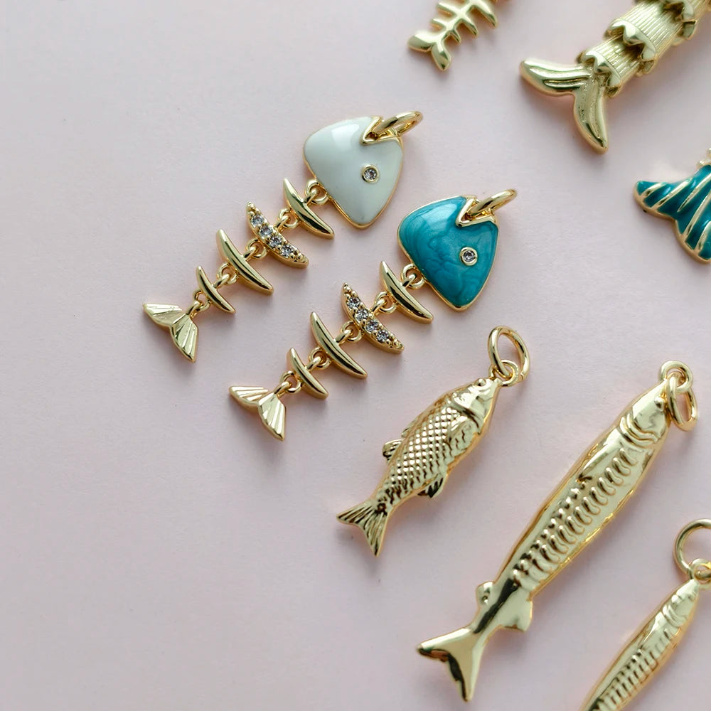 Gold and enamel charms on a pink background