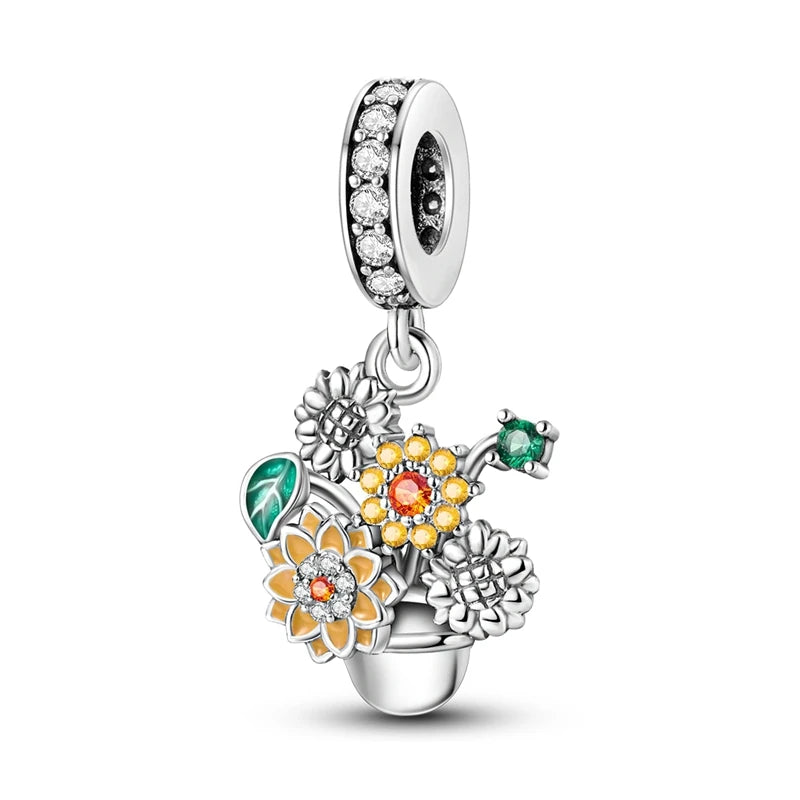 Silver charm with floral design and colored stones on a white background