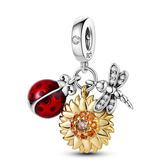 Jewelry charm with ladybug, sunflower, and dragonfly on a white background