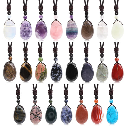 Collection of various stone pendants on brown cord necklaces against a white background