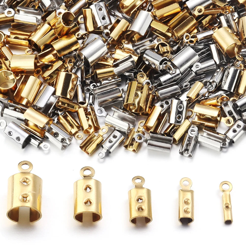 A pile of small metal connector caps in gold and silver finishes, with five individual gold-toned pieces displayed in front on a white background.