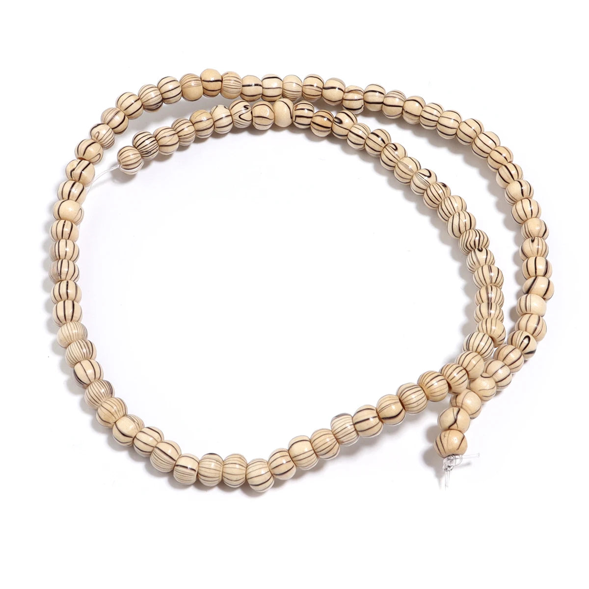 Beige beaded necklace on a white background