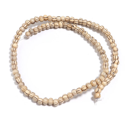 Beige beaded necklace on a white background