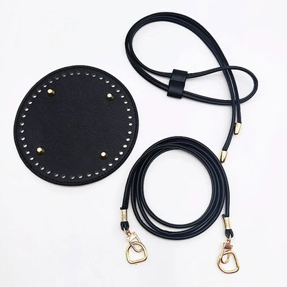 Black leather strap with gold hardware on a white background