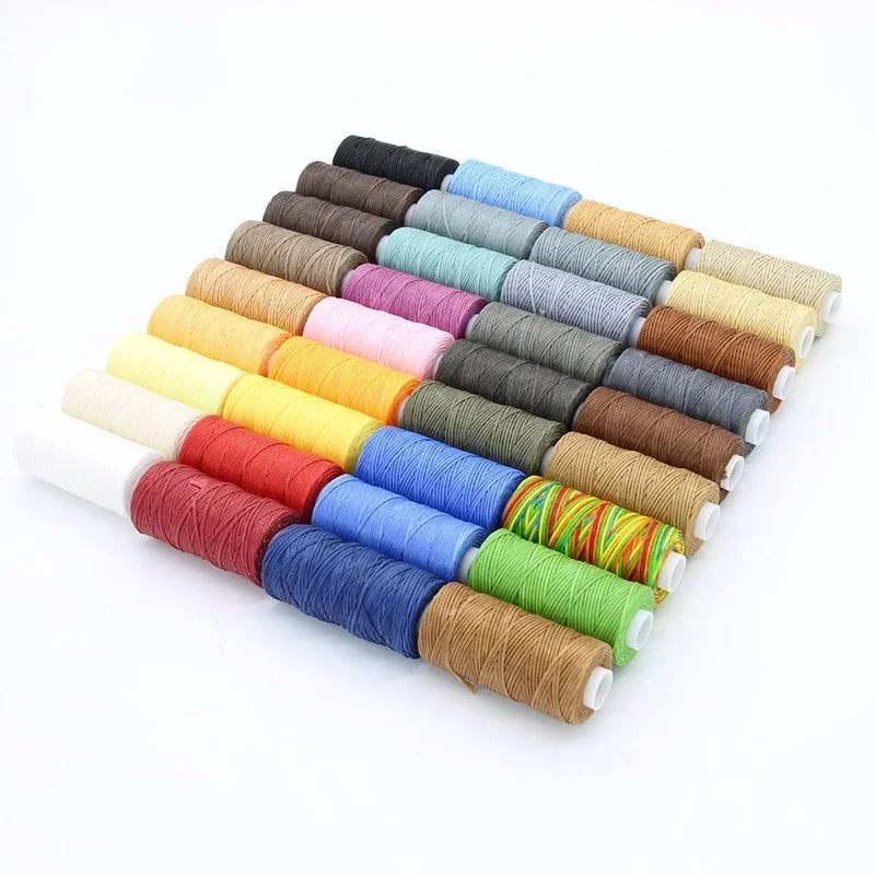 Assorted spools of thread in various colors on a white background