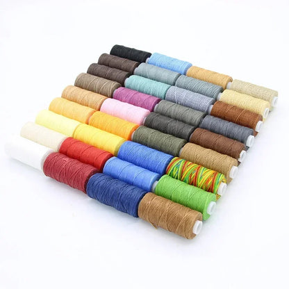 Assorted spools of thread in various colors on a white background