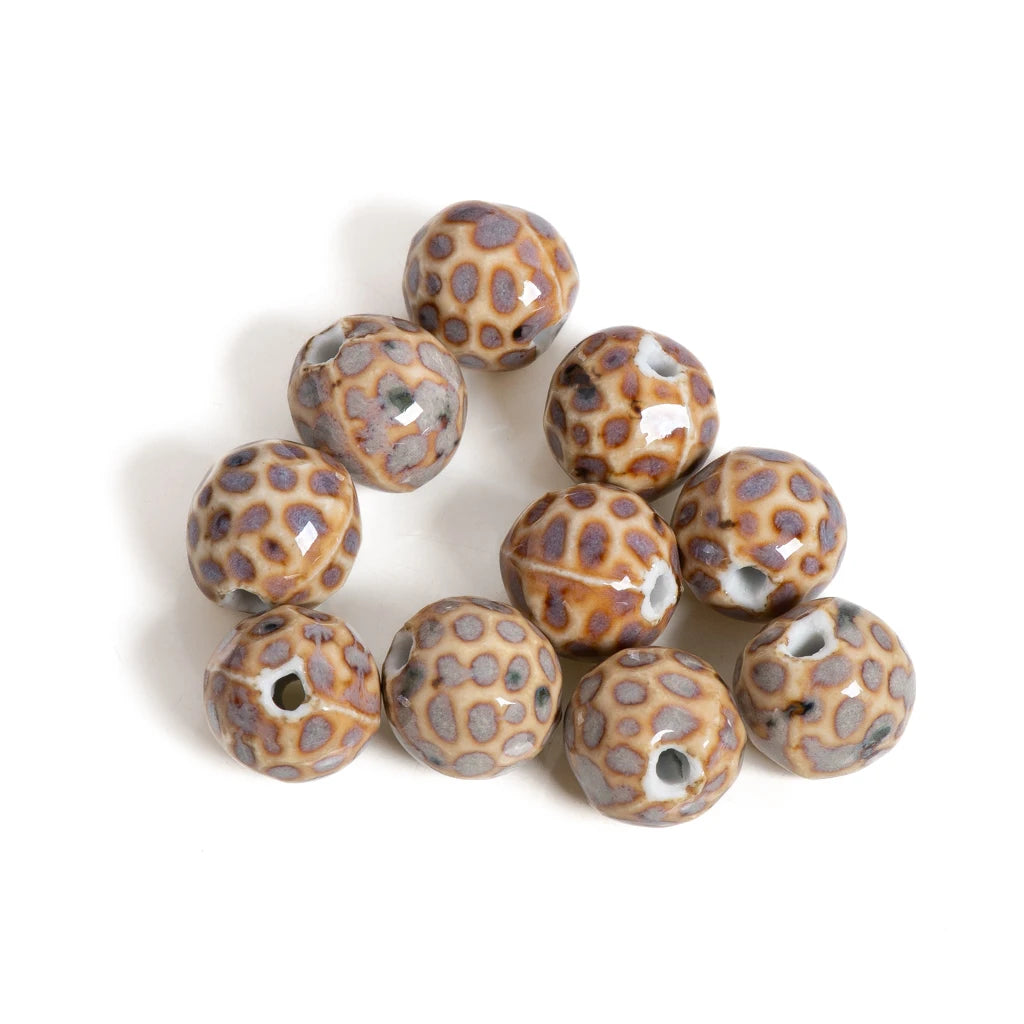 A cluster of round ceramic beads with a brown and gray spotted animal print pattern, shown on a plain white background.