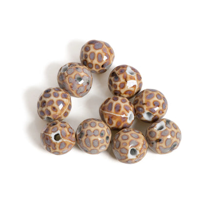 A cluster of round ceramic beads with a brown and gray spotted animal print pattern, shown on a plain white background.